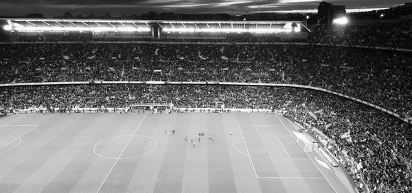 High angle view of people on soccer field at night