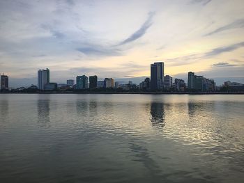 City at waterfront during sunset