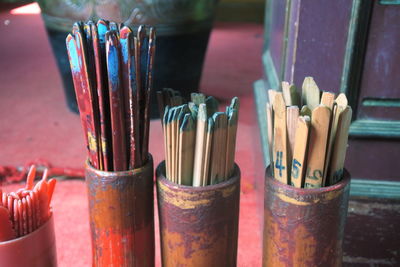 Close-up of wooden sticks in containers
