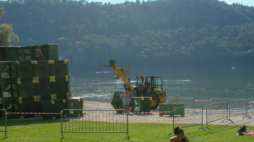 People on land by sea against sky