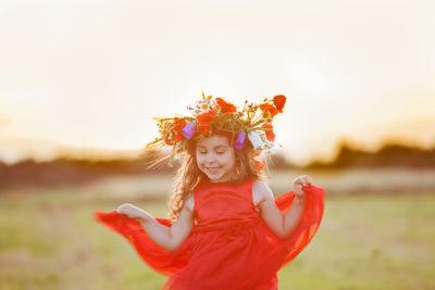 Smiling girl wearing dress on field