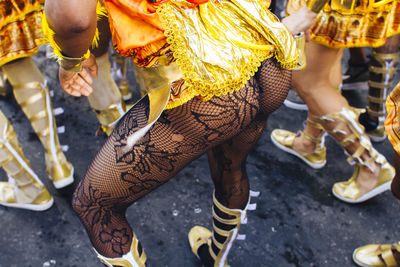 Low section of females in costume during carnival