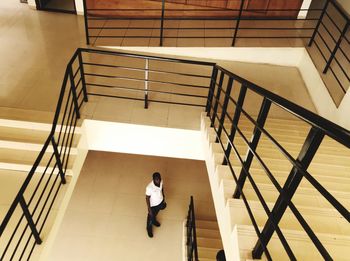 High angle view of woman standing on stairs