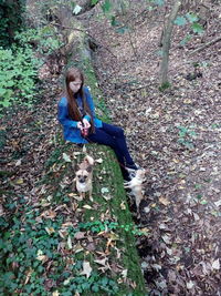 Portrait of smiling young woman standing in forest