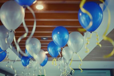 Low angle view of balloons against ceiling