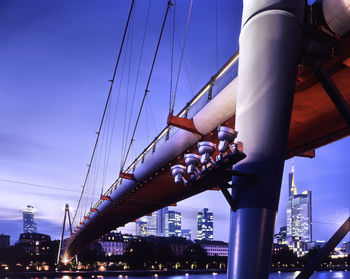 Low angle view of bridge in city against sky