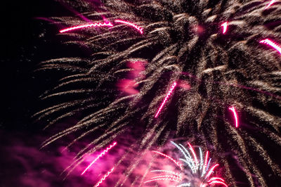 Low angle view of firework display at night