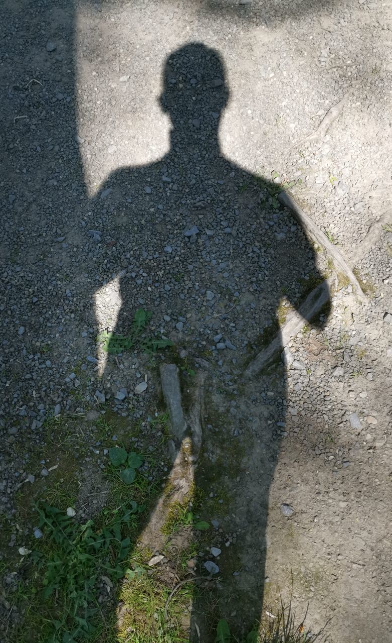 HIGH ANGLE VIEW OF PEOPLE SHADOW ON STREET