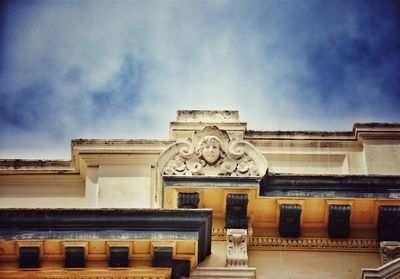 Low angle view of building against blue sky