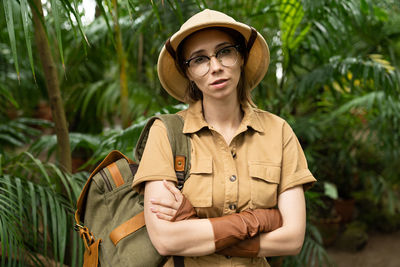 Portrait of woman standing in forest