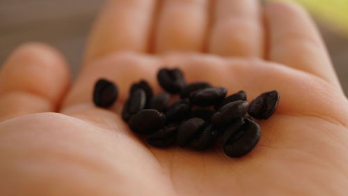 Close-up of hand holding black coffee