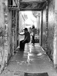 Rear view of people walking in corridor of building