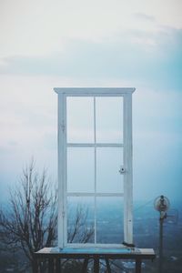 Metallic structure by sea against sky