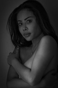 Portrait of beautiful woman against black background