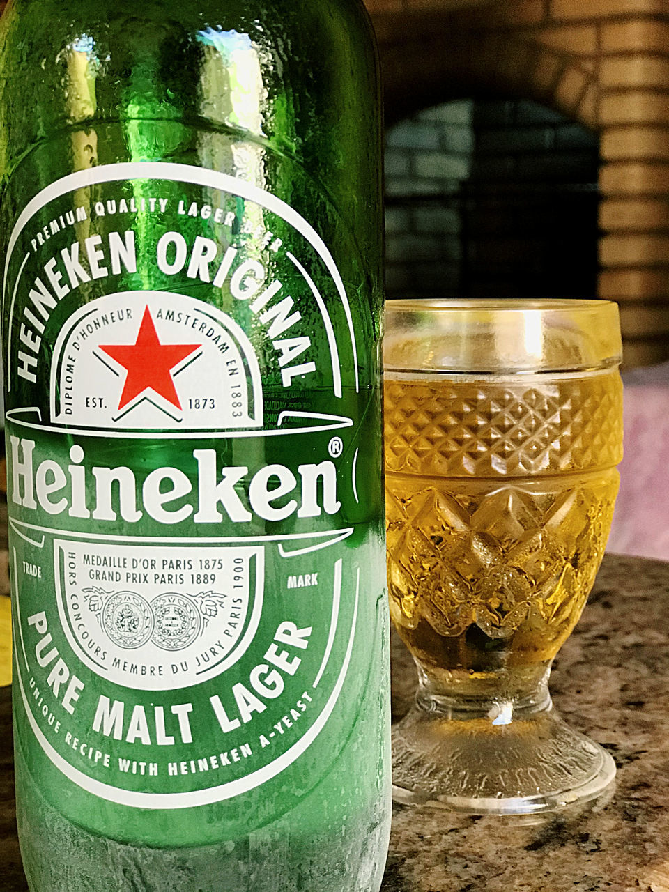 CLOSE-UP OF BEER GLASS WITH BOTTLES