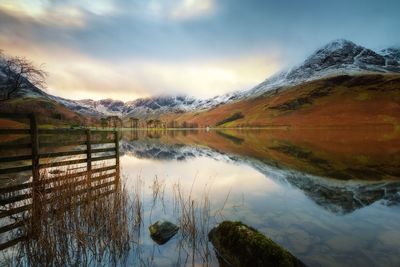 Scenic view of lake and mountains against sky