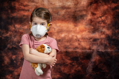 Portrait of cute baby girl holding toy