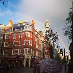 Low angle view of buildings against cloudy sky