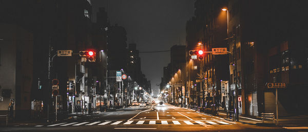 Illuminated city street at night