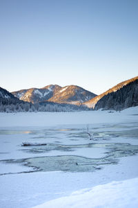 Scenic view of snowcapped mountains against clear sky