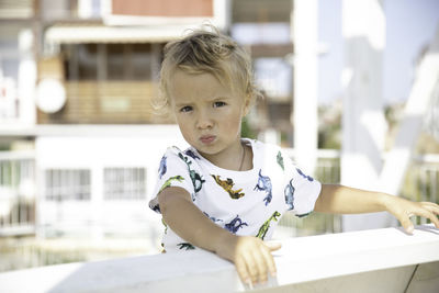 Portrait of cute baby boy sitting on table