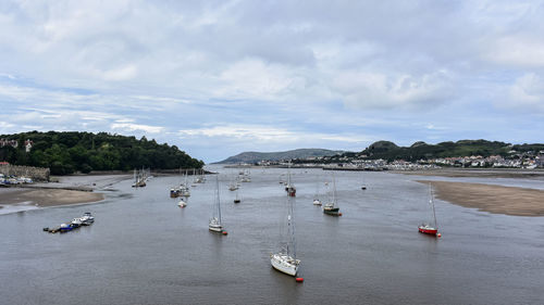 High angle view of sailboats moored in sea against sky