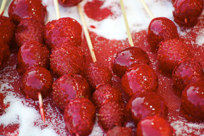 Close-up of strawberries on skewers with syrup