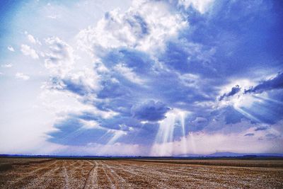 Scenic view of landscape against cloudy sky