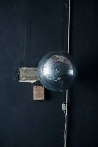 Close-up of lighting equipment hanging against wall