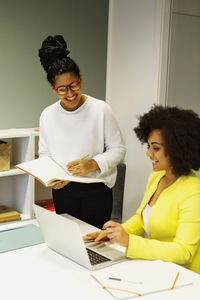 Women using laptop in office