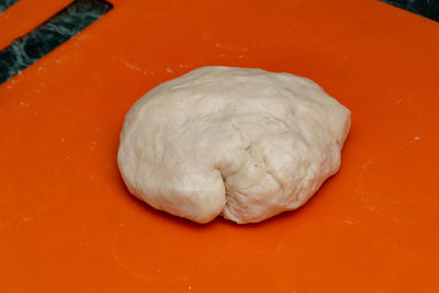 High angle view of bread on orange table