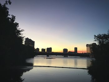 Reflection of city in water against sky