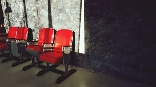 Red empty chairs in room