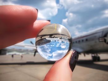 Cropped image of hand holding crystal ball