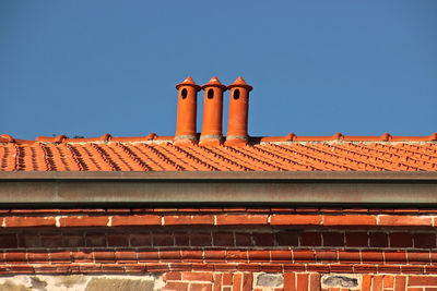 Low angle view of building against clear blue sky during sunny day