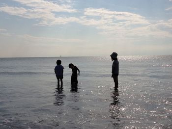 Friends standing on beach