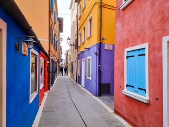 Street amidst colorful buildings in city