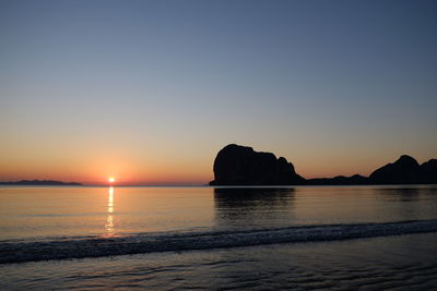 Scenic view of sea against clear sky during sunset