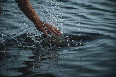 Person splashing water in lake