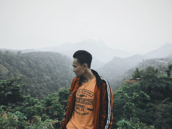 Man standing on mountain against sky