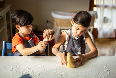 Two concentrated girls preparing the food at home