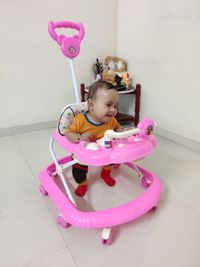 Cute girl playing with toy on floor