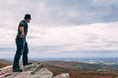 Full length of man standing on landscape against sky