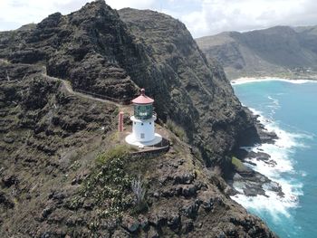 Scenic view of sea and mountains against sky