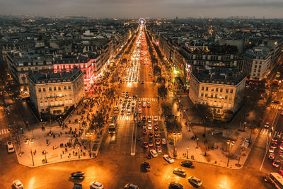 High angle view of illuminated city street amidst buildings