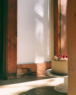 Potted plant on table by window of building