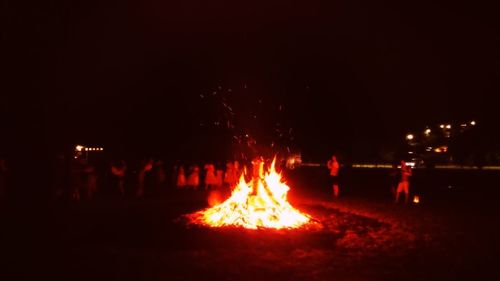 Close-up of bonfire against sky at night