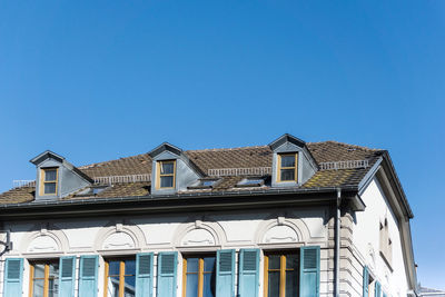 Low angle view of built structure against clear blue sky