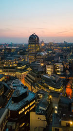 High angle view of illuminated buildings in city at dusk