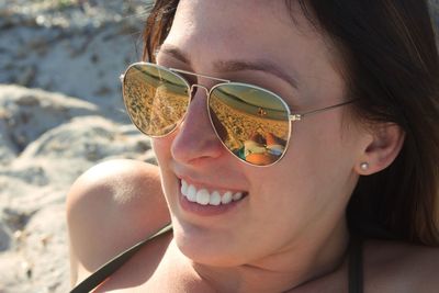 Close-up portrait of young woman wearing sunglasses